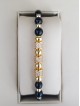 Bratara dama model deosebit cu margele aurii si negre si cercuri cu pietre stralucitoare