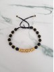 Bratara dama model deosebit cu margele aurii si negre si cercuri cu pietre stralucitoare