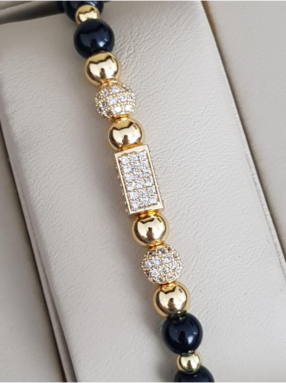 Bratara dama model deosebit cu margele aurii si negre si forme cu pietricele stralucitoare
