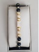 Bratara dama model deosebit cu margele aurii si negre si forme cu pietricele stralucitoare