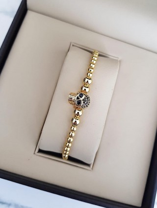 Bratara dama model deosebit cu margele aurii si skull cu pietricele negre
