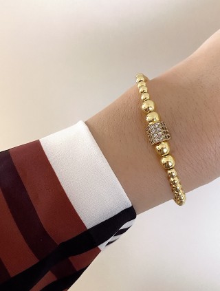 Bratara dama model deosebit cu margele aurii si forma cu pietricele stralucitoare