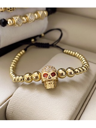 Bratara dama model deosebit cu margele aurii si craniu auriu