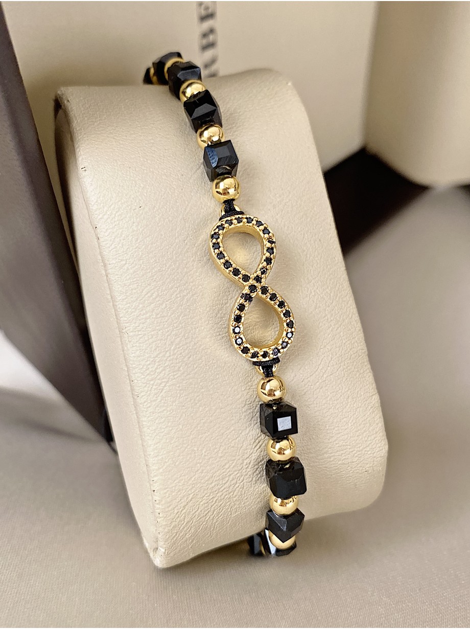 Bratara dama model deosebit cu margele negre cu auriu si infinit cu pietricele stralucitoare