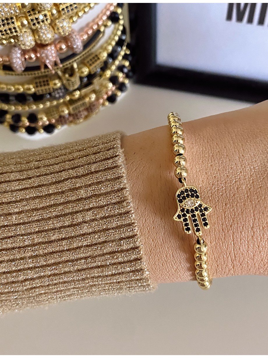 Bratara dama model deosebit cu margele aurii si palma cu pietricele negre