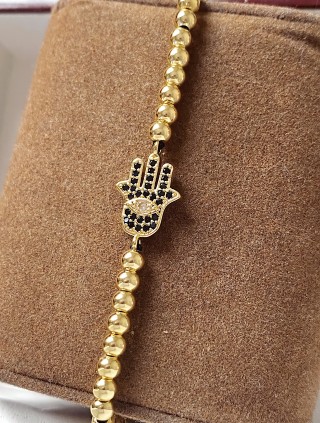 Bratara dama model deosebit cu margele aurii si palma cu pietricele negre