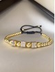 Bratara dama model deosebit cu margele aurii si patrate cu pietricele stralucitoare