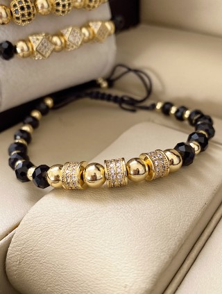 Bratara dama model deosebit cu margele aurii si negre si cercuri cu pietre stralucitoare