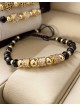 Bratara dama model deosebit cu margele aurii si negre si cercuri cu pietre stralucitoare