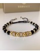 Bratara dama model deosebit cu margele aurii si negre si cercuri cu pietre stralucitoare