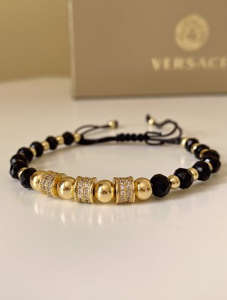 Bratara dama model deosebit cu margele aurii si negre si cercuri cu pietre stralucitoare