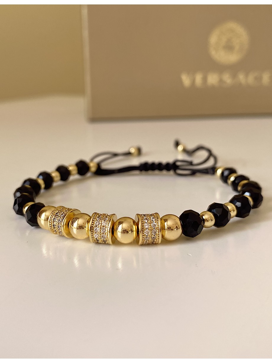 Bratara dama model deosebit cu margele aurii si negre si cercuri cu pietre stralucitoare