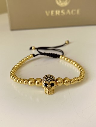 Bratara dama model deosebit cu margele aurii si craniu auriu