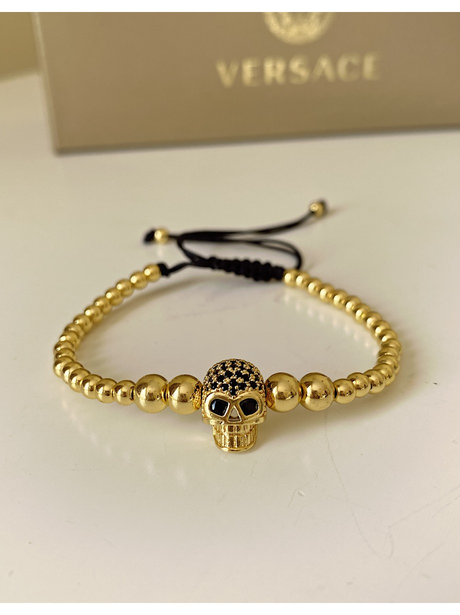 Bratara dama model deosebit cu margele aurii si craniu auriu