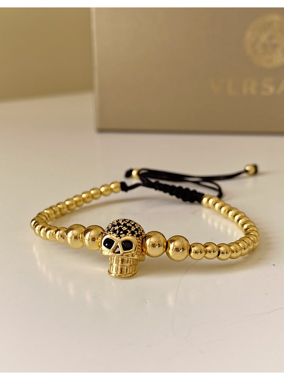 Bratara dama model deosebit cu margele aurii si craniu auriu