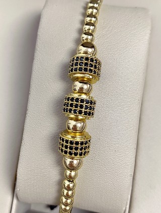 Bratara dama model deosebit cu margele aurii si cercuri cu pietricele negre