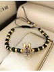 Bratara dama model deosebit cu margele negre si aurii si coroana