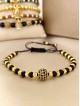 Bratara dama model deosebit cu margele negre si aurii si biluta