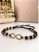 Bratara dama model deosebit cu margele negre cu auriu si infinit cu pietricele stralucitoare