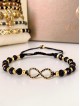 Bratara dama model deosebit cu margele negre cu auriu si infinit cu pietricele stralucitoare