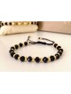 Bratara dama model deosebit cu margele negre cu auriu si design simplu
