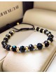 Bratara dama model deosebit cu margele negre cu auriu si design simplu