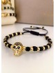Bratara dama model deosebit cu margele negre si aurii si craniu