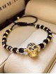 Bratara dama model deosebit cu margele negre si aurii si craniu