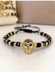 Bratara dama model deosebit cu margele negre si aurii si craniu