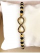 Bratara dama model deosebit cu margele negre cu auriu si infinit cu pietricele stralucitoare