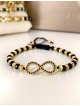 Bratara dama model deosebit cu margele negre cu auriu si infinit cu pietricele stralucitoare