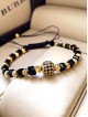 Bratara dama model deosebit cu margele aurii si negre si biluta cu pietricele negre